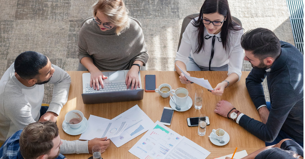 A team sits together at a round table.